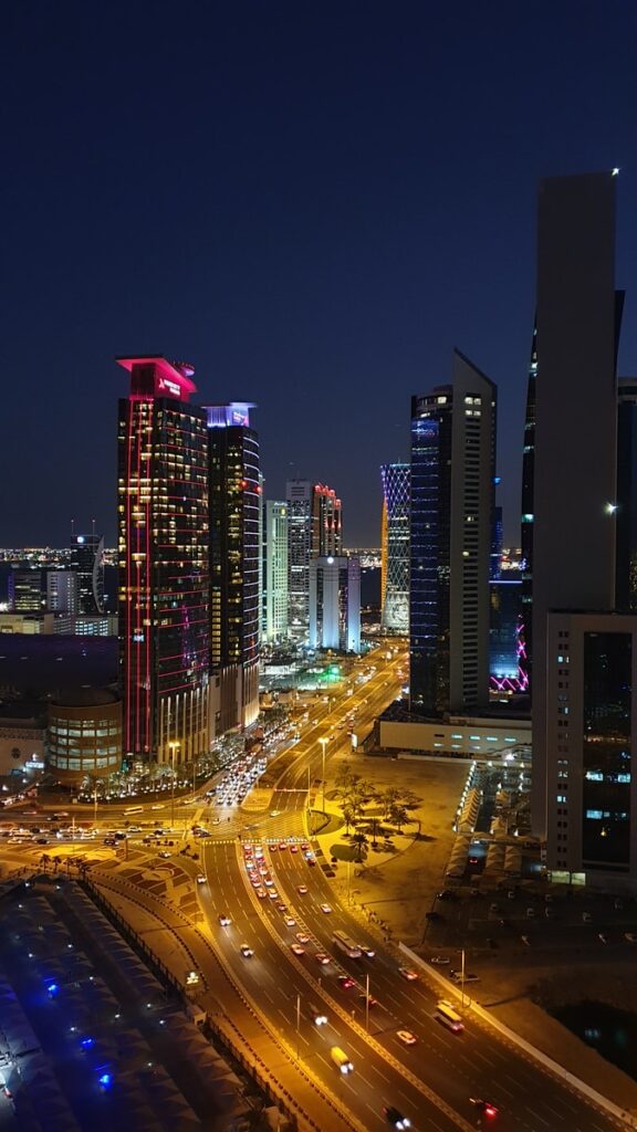 high-angle photography of cars on road between high-rise buildings